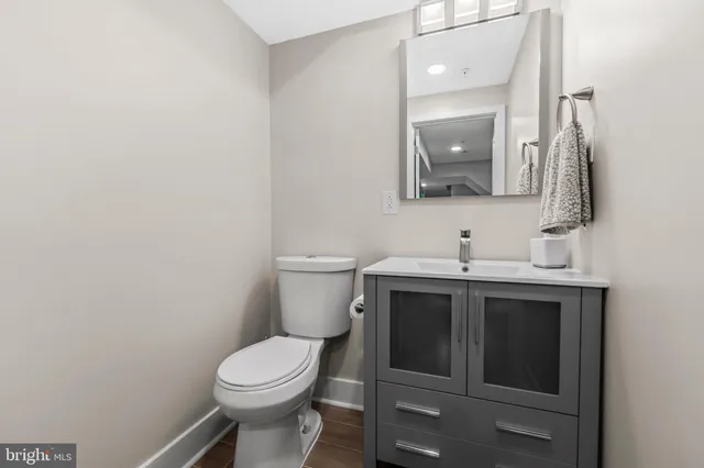 a bathroom with a toilet sink and mirror