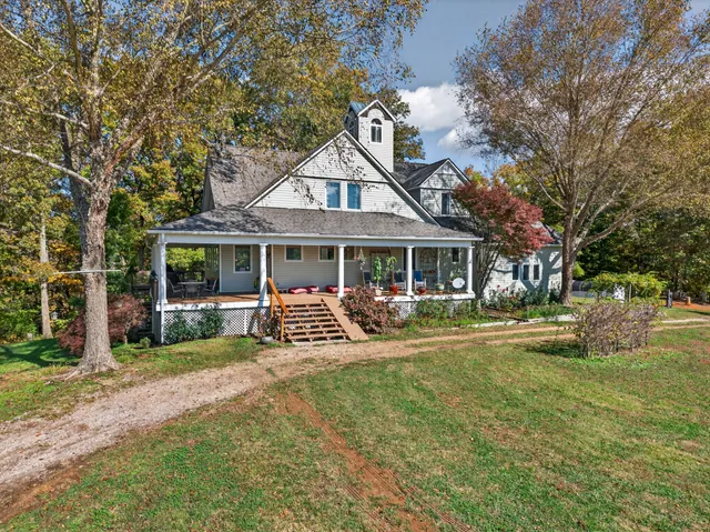 a front view of a house with garden and porch