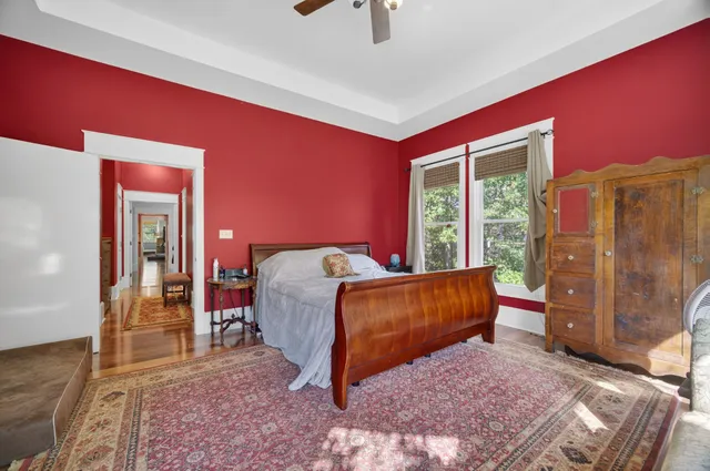 a bedroom with a bed and a ceiling fan
