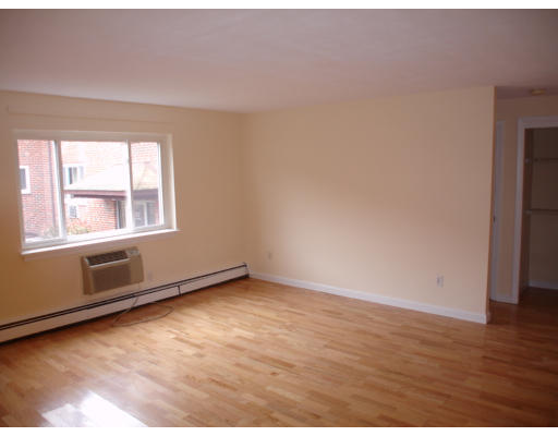 44A Bryon Road, Unit 3 Chestnut Hill, MA 02467 - Photo 3 of 4 a view of an empty room with wooden floor and a window