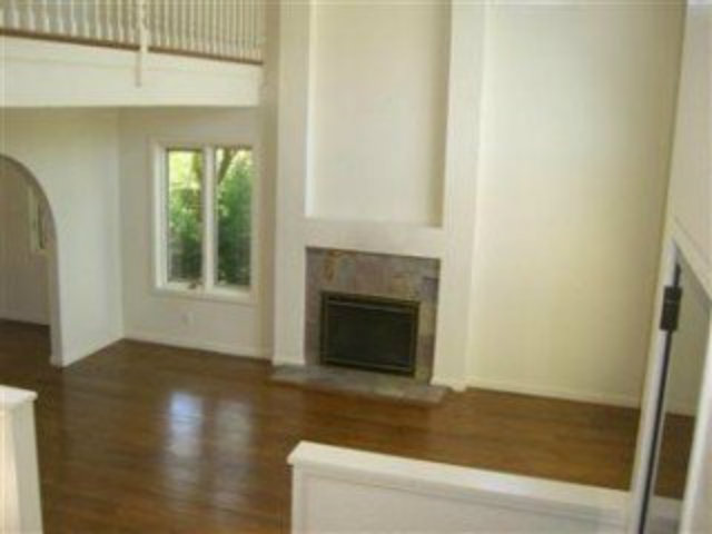 251 La Prenda Millbrae, CA 94030 - Photo 4 of 10 a view of a livingroom with wooden floor and a fireplace