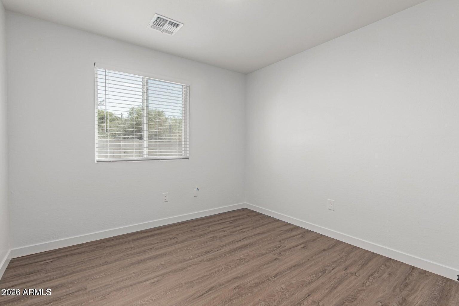 450 South Crismon Road, Unit 2 Mesa, AZ 85208 - Photo 15 of 21 wooden floor in an empty room with a window