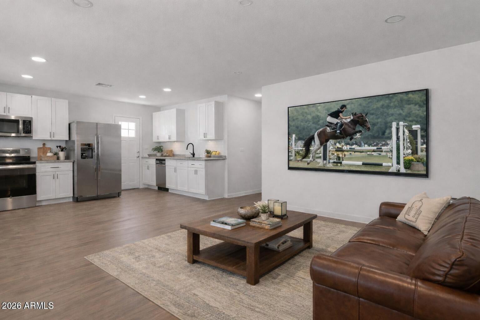 450 South Crismon Road, Unit 2 Mesa, AZ 85208 - Photo 5 of 21 a living room with stainless steel appliances kitchen island granite countertop a couch and a view of kitchen sink