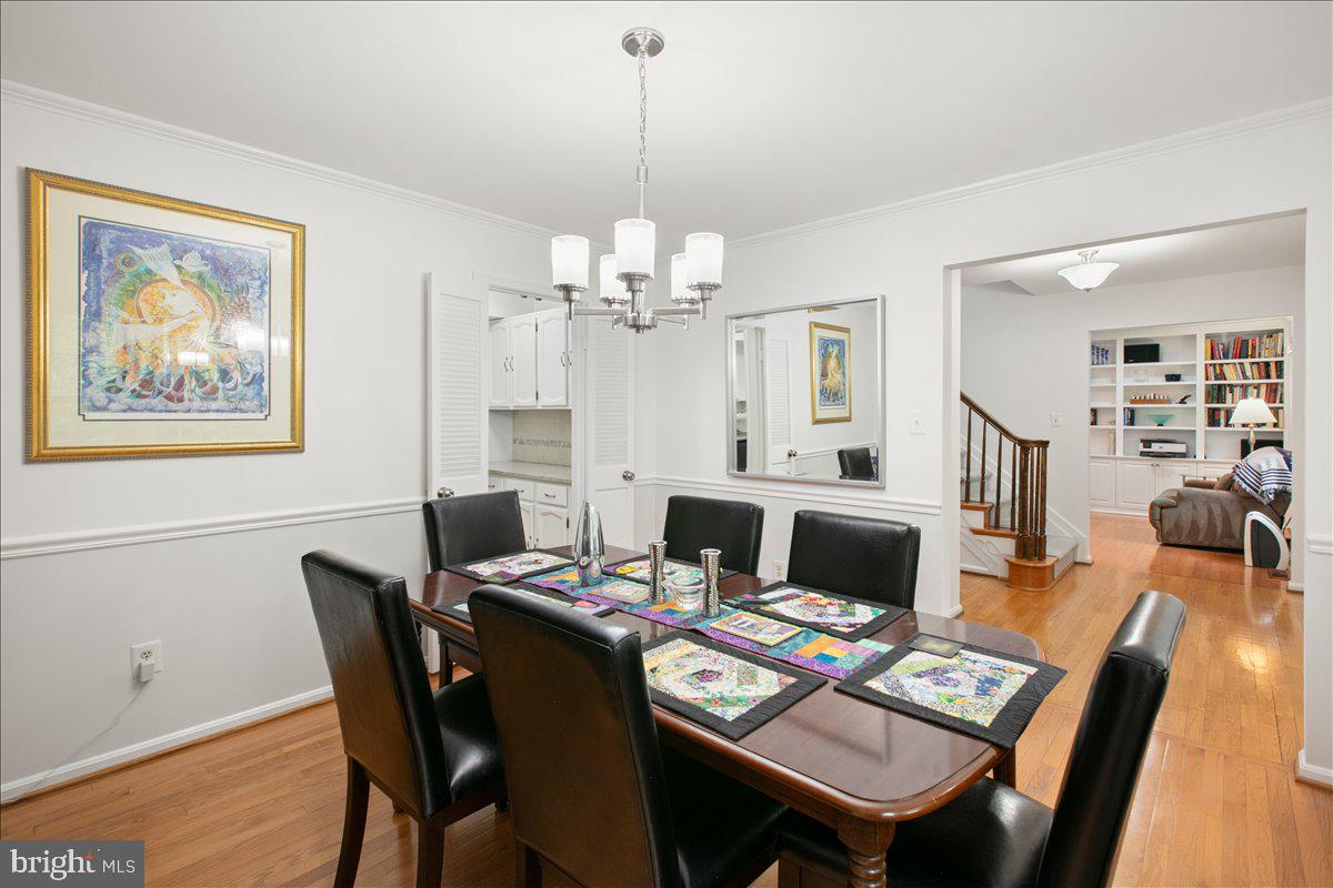 10741 Midsummer Drive Reston, VA 20191 - Photo 18 of 53 a view of a dining room with furniture and a chandelier