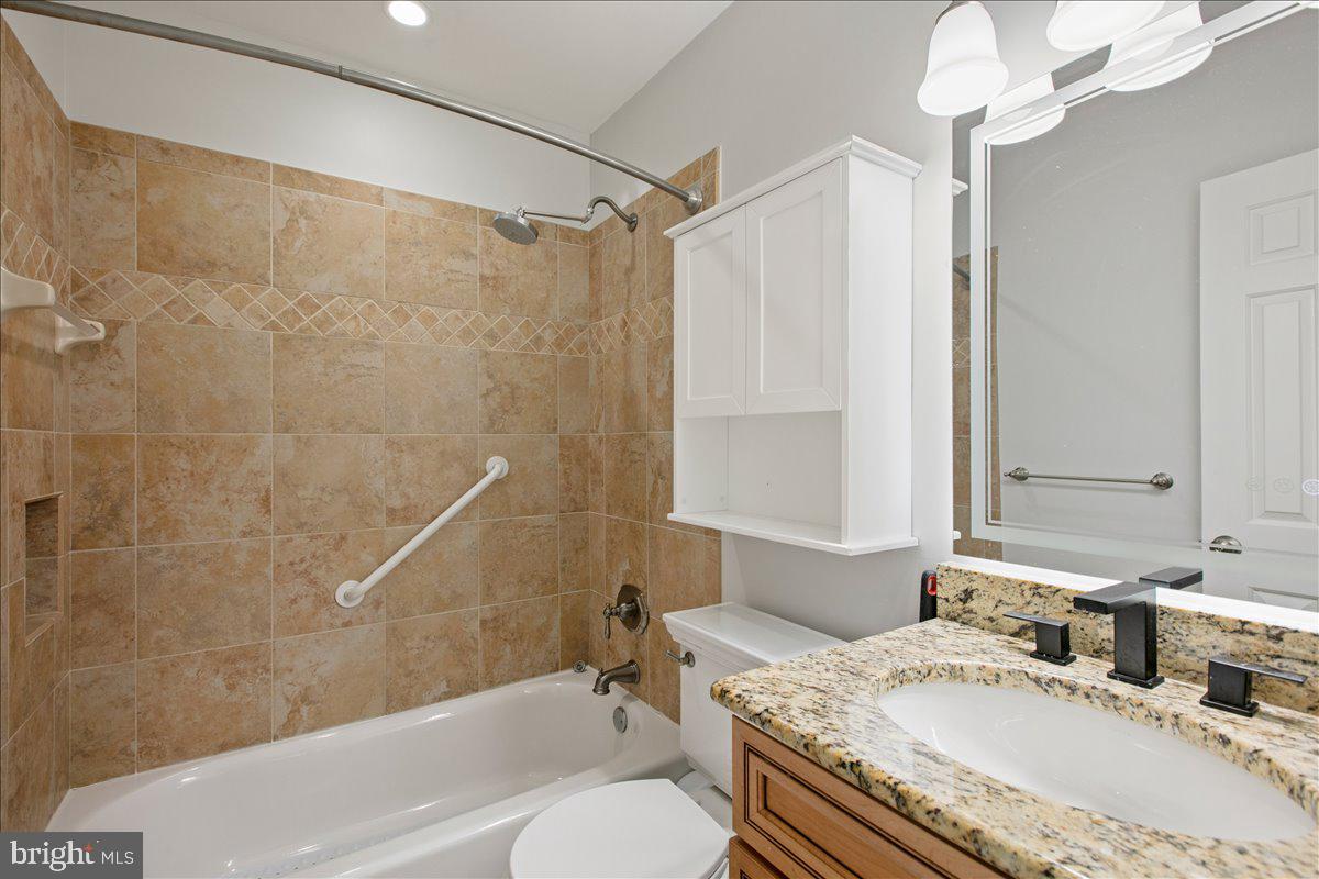 10741 Midsummer Drive Reston, VA 20191 - Photo 43 of 53 a bathroom with a granite countertop sink toilet and shower