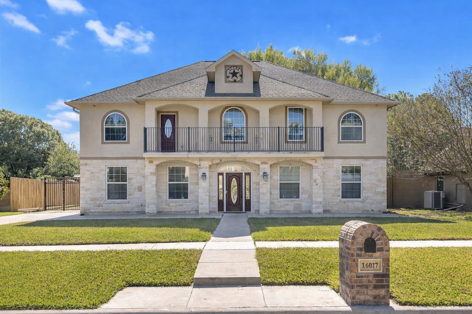 Beautiful two-story home with a timeless stucco and stone exterior, featuring a grand, symmetrical design, arched windows, double-door entry, and a second-floor balcony with iron railing. The home offers strong curb appeal and an impressive presence.
This image has been digitally enhanced using AI to present a cleaner front exterior by removing landscaping for visualization purposes.