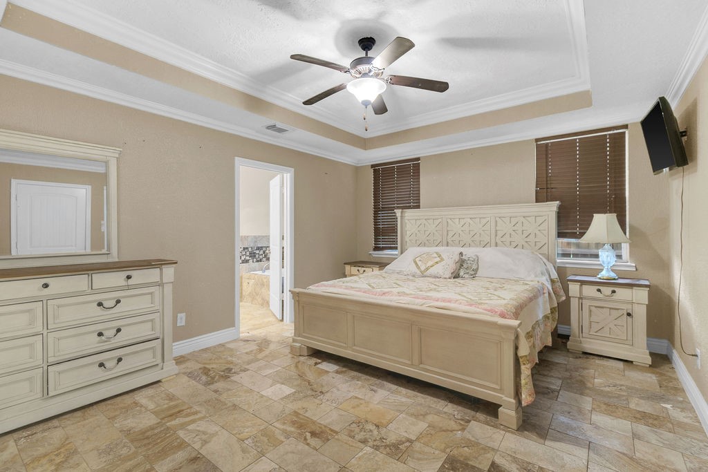 16017 Congo Lane Jersey Village, TX 77040 - Photo 11 of 13 a spacious bedroom with a bed and a flat screen tv