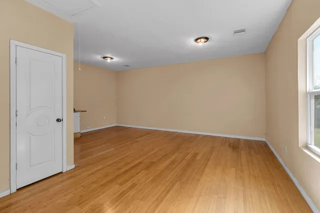wooden floor in an empty room with a window