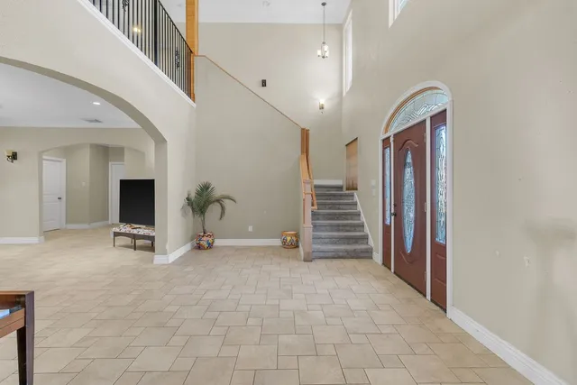 a dining room with furniture a chandelier and window