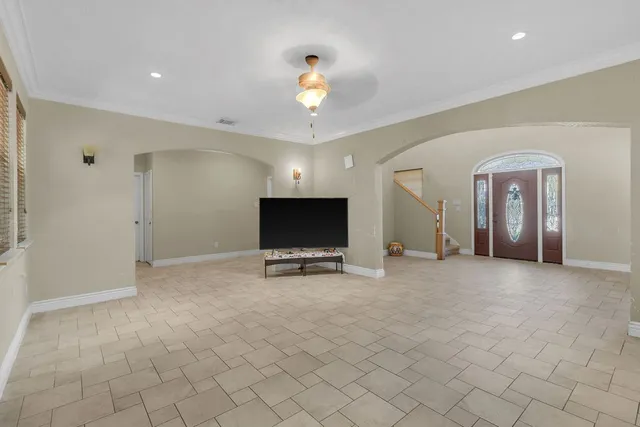 a spacious bedroom with a bed and a flat screen tv