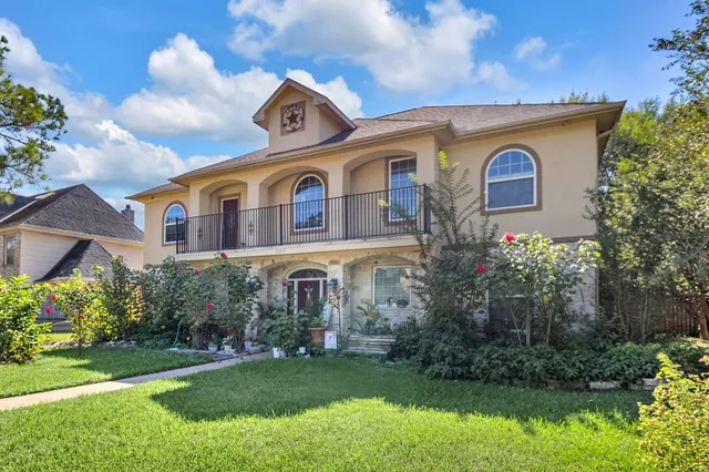 a front view of house with yard and green space
