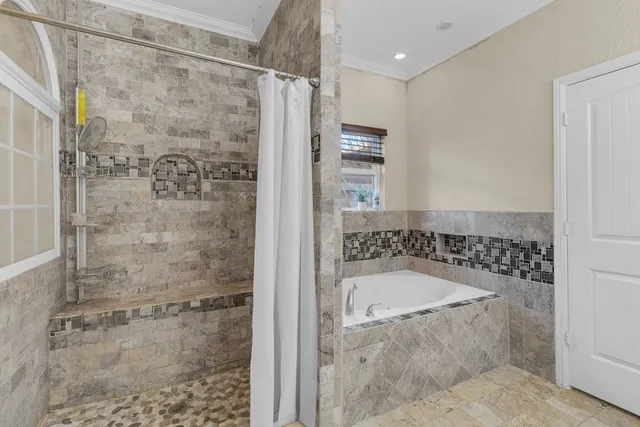 a spacious bathroom with a granite countertop sink a mirror and a shower