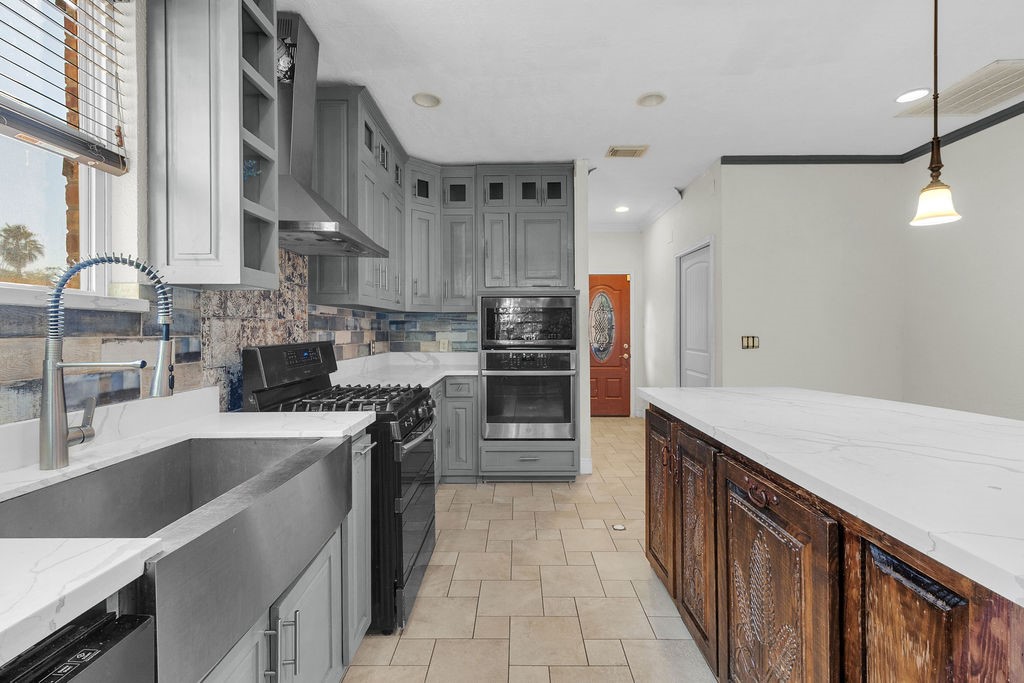 16017 Congo Lane Jersey Village, TX 77040 - Photo 5 of 13 a kitchen with stainless steel appliances granite countertop a sink a stove and a refrigerator