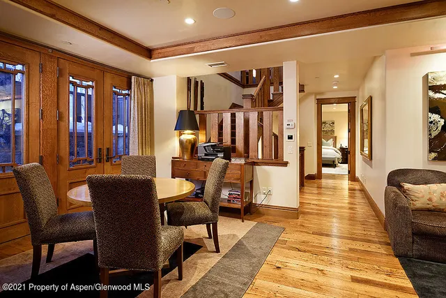 a dining room with furniture and wooden floor