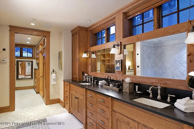 a spacious bathroom with a double vanity sink and a mirror