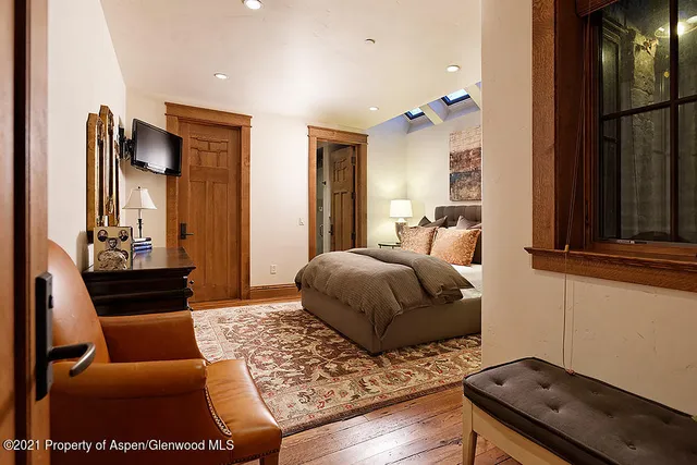 a bedroom with furniture and a window