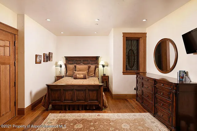 a bedroom with a bed and a dresser