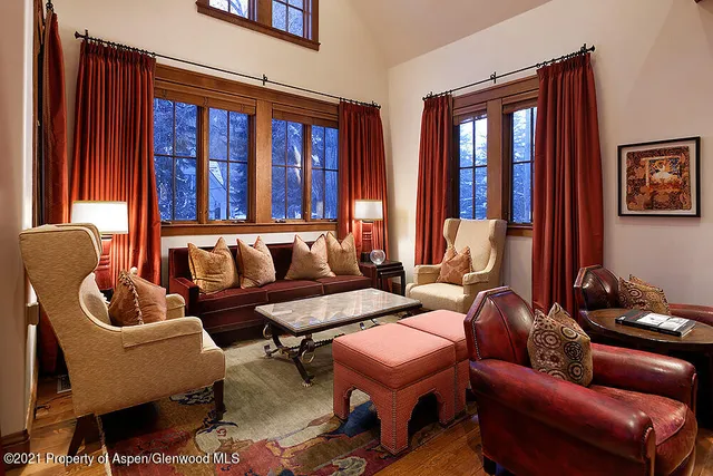 a media room with lots of chairs and a chandelier