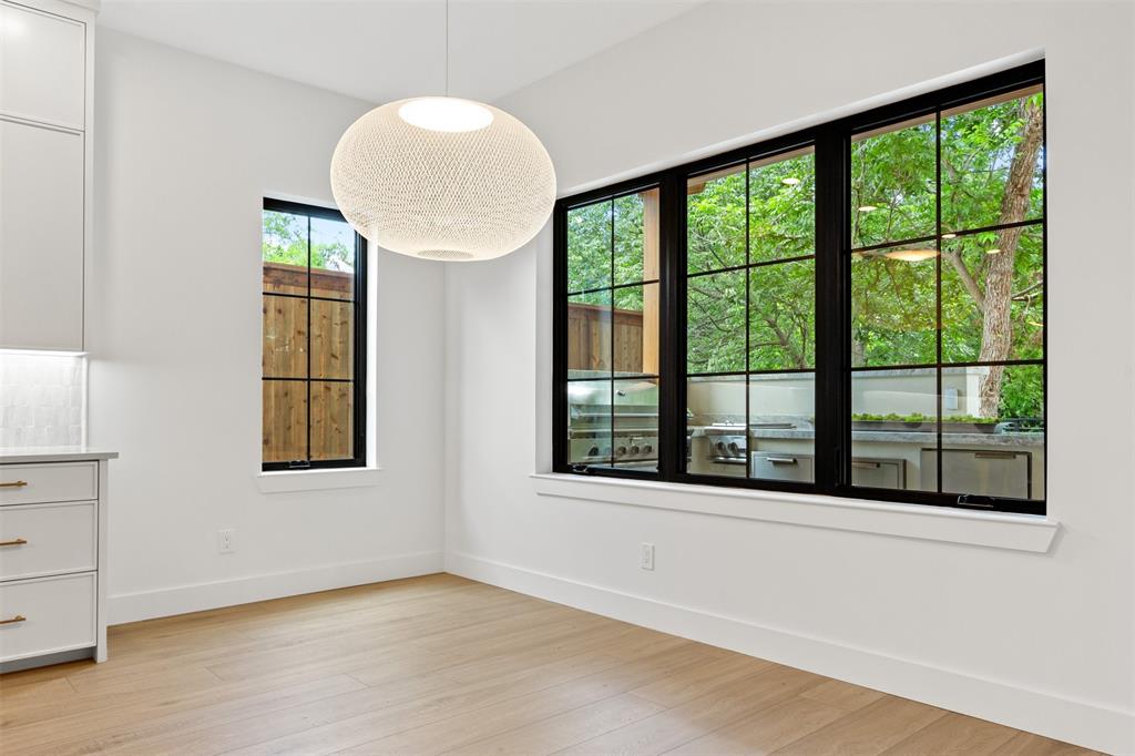 6446 Lange Circle Dallas, TX 75214 - Photo 12 of 40 a view of an empty room with a window and wooden floor