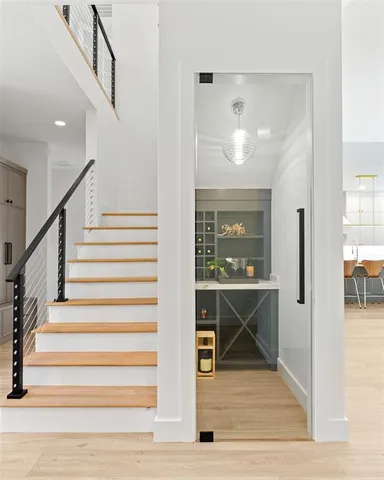 a view of entryway and hall with wooden floor