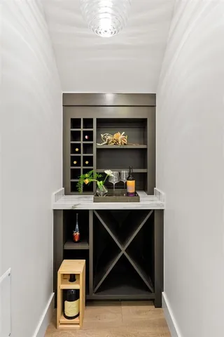 an empty room with windows and mirror