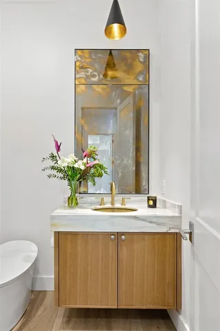 a view of a kitchen with furniture and wooden floor