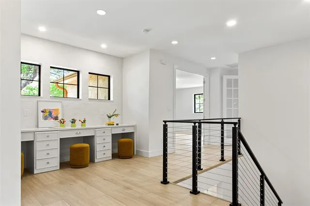 a hallway with a window and cabinets