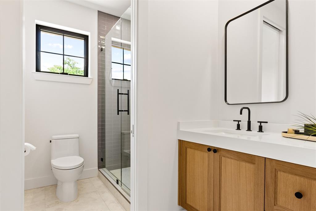6446 Lange Circle Dallas, TX 75214 - Photo 30 of 40 a bathroom with a toilet sink vanity and mirror