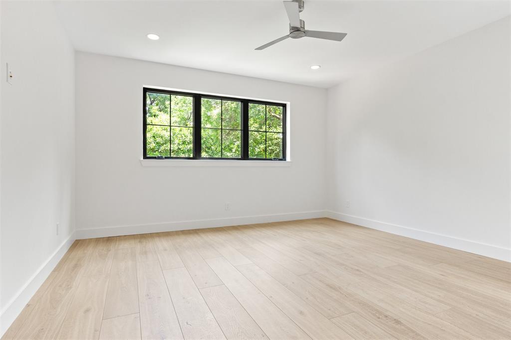 6446 Lange Circle Dallas, TX 75214 - Photo 32 of 40 an empty room with wooden floor fan and windows