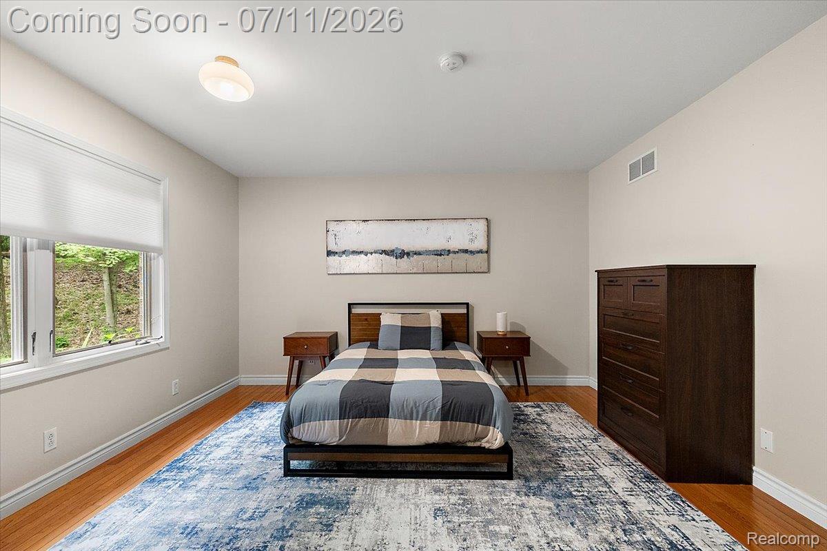 4219 Gardner Road Metamora, MI 48455 - Photo 41 of 87 Spacious room featuring wood-finish flooring, light-toned walls, and a large window with privacy blinds