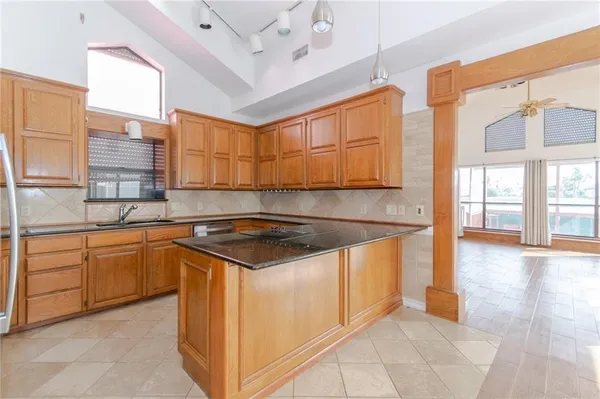 a kitchen with stainless steel appliances granite countertop a sink and cabinets