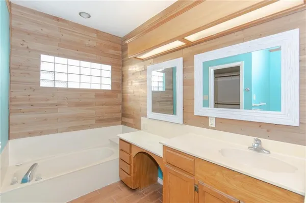 a bathroom with a bathtub and a sink