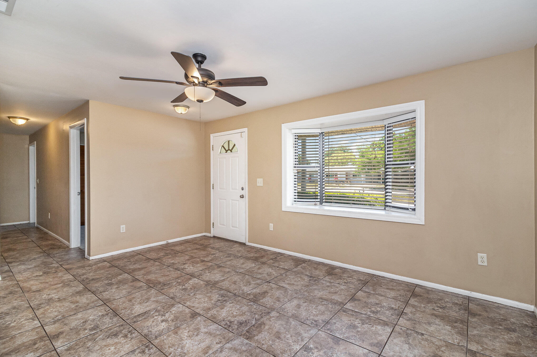 635 Croton Road Melbourne, FL 32935 - Photo 11 of 22 a view of an empty room with a ceiling fan and a window