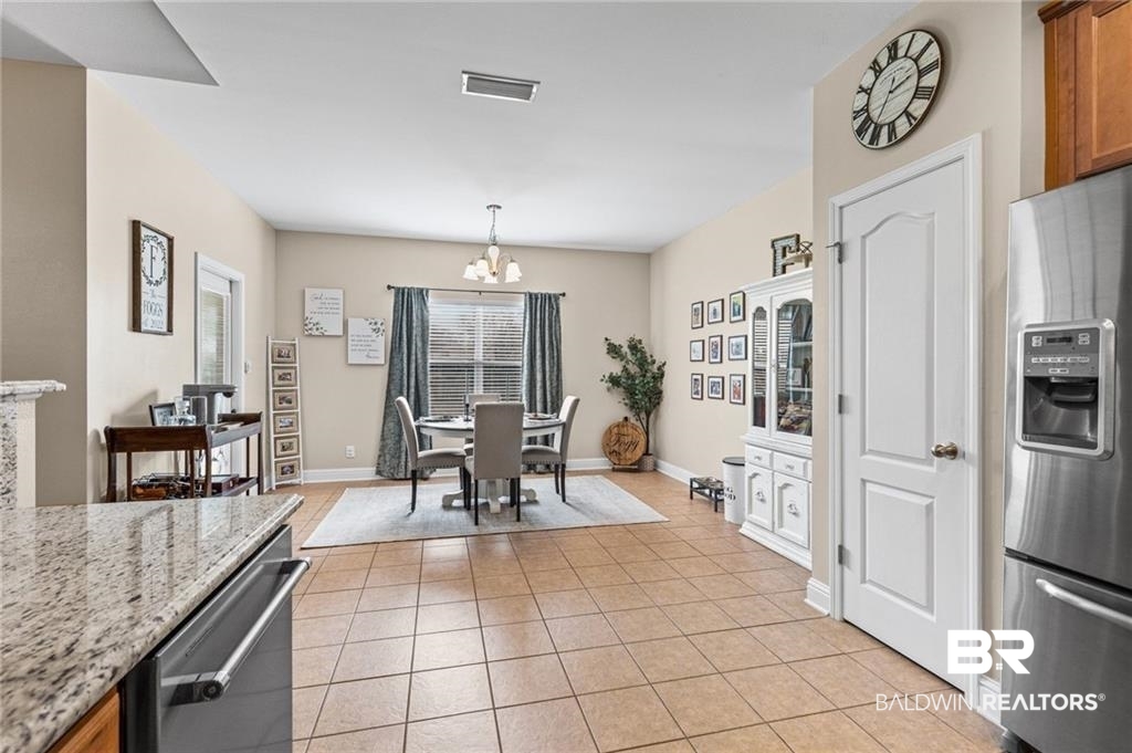 2570 Pecan Pointe Drive Semmes, AL 36575 - Photo 7 of 22 Dining room with a chandelier and light tile patterned floors