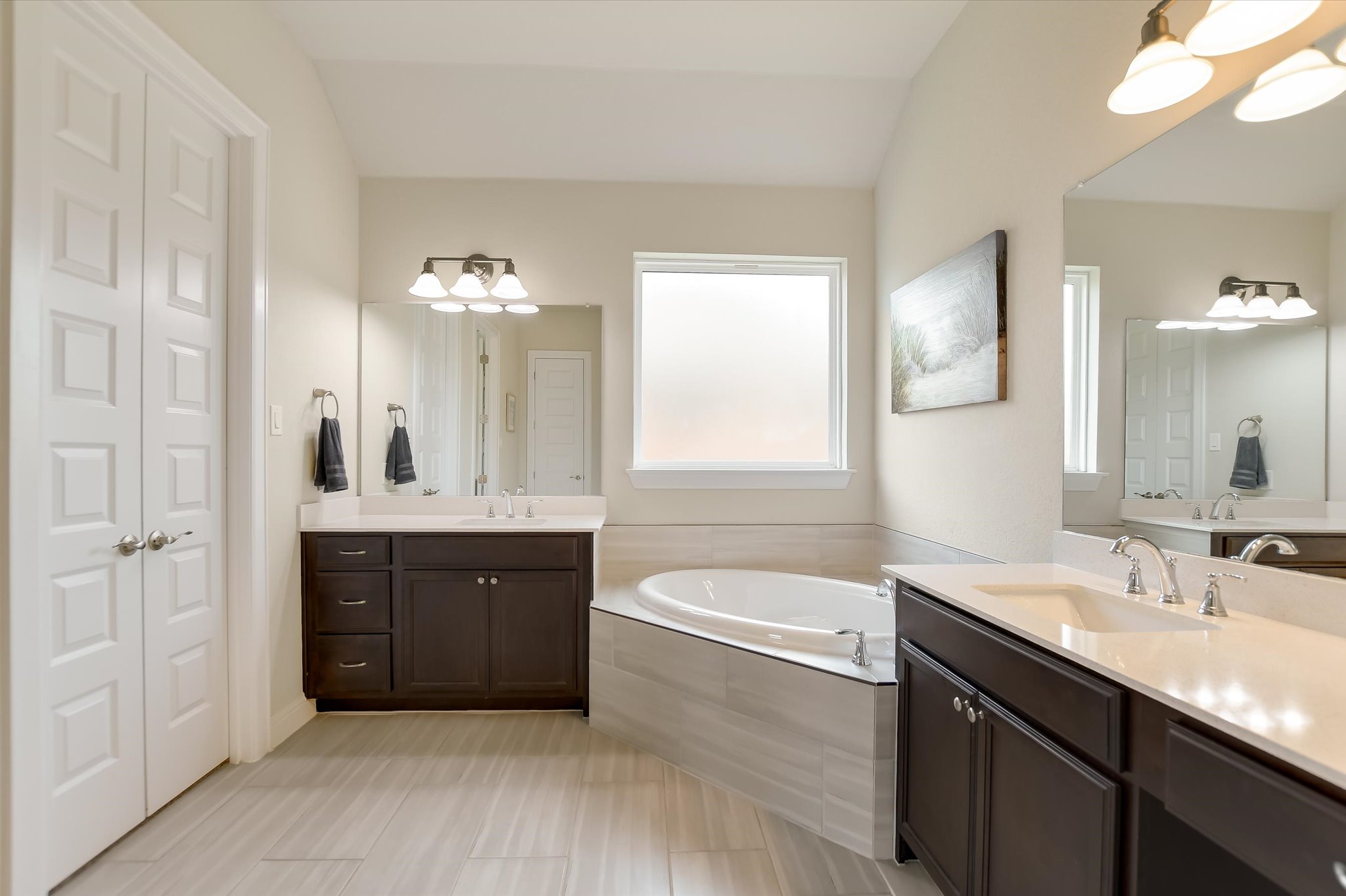 2009 Waterview Road Georgetown, TX 78628 - Photo 13 of 22 a bathroom with a tub a sink double vanity and a mirror