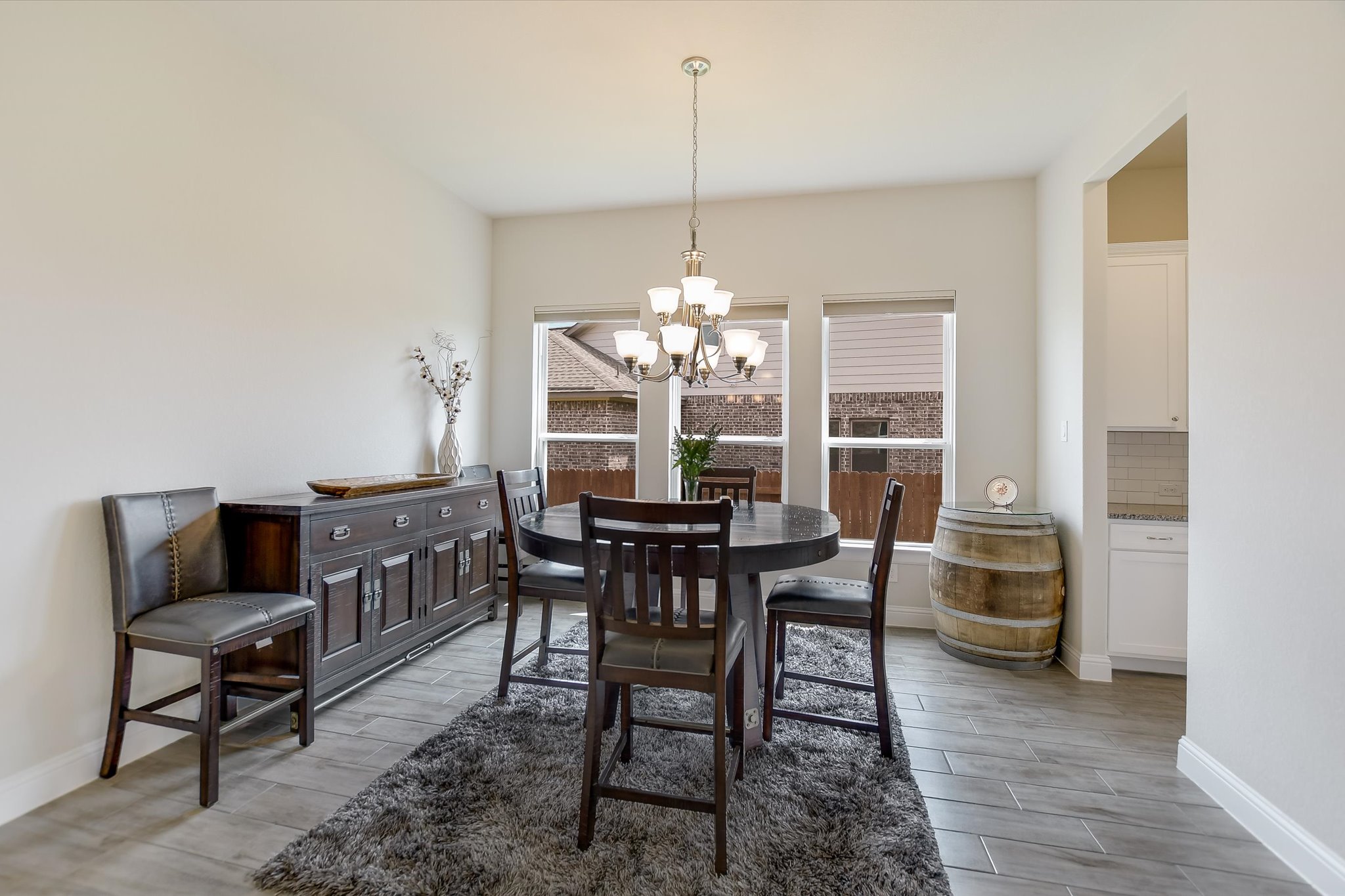 2009 Waterview Road Georgetown, TX 78628 - Photo 7 of 22 a dining room with furniture a chandelier and wooden floor