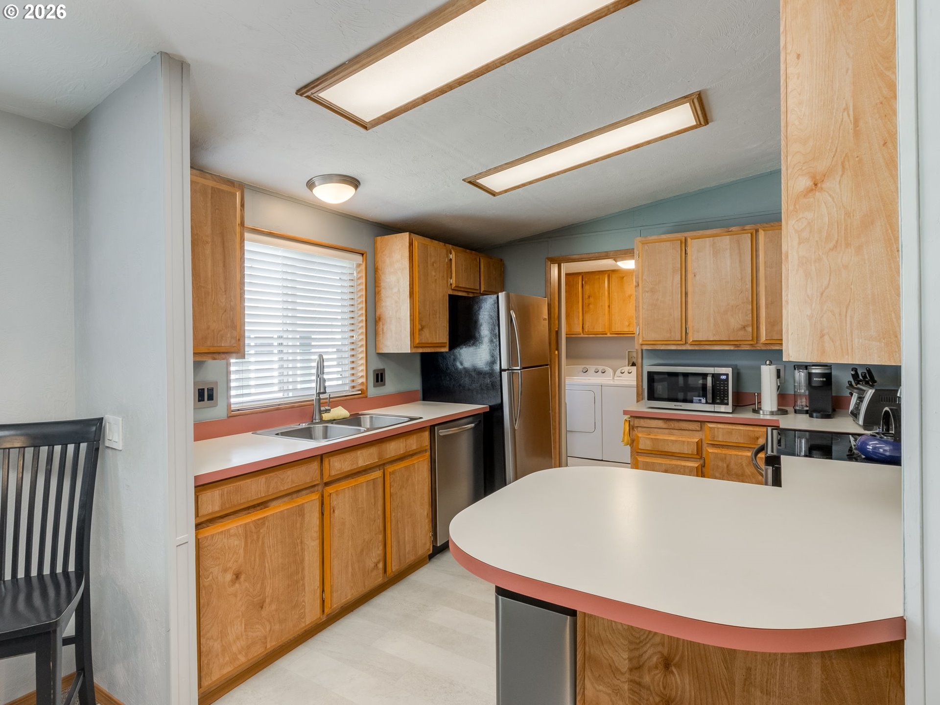 4730 Auburn Road Northeast, Unit 125 Salem, OR 97301 - Photo 7 of 36 a kitchen with stainless steel appliances granite countertop a sink a stove and refrigerator