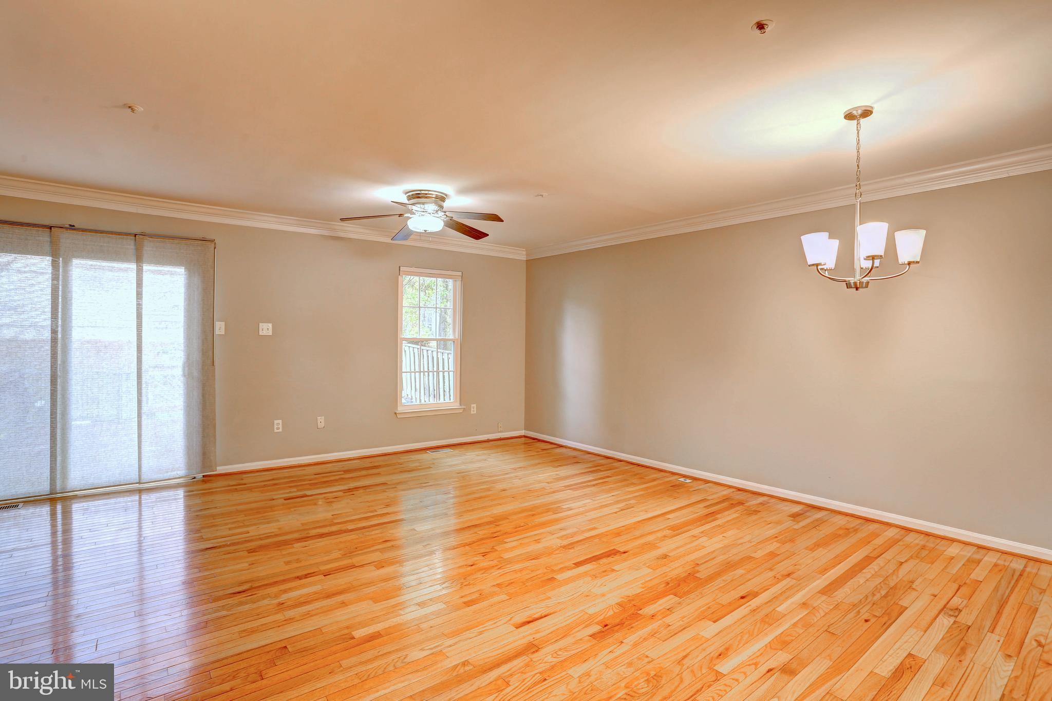 6136 Starburn Path Columbia, MD 21045 - Photo 7 of 35 a view of an empty room with wooden floor and a window