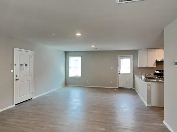 a view of a kitchen with a sink a refrigerator and window