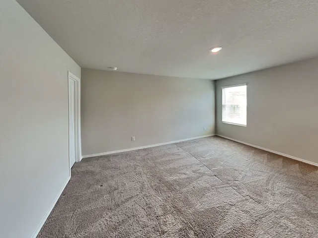 an empty room with windows and closet