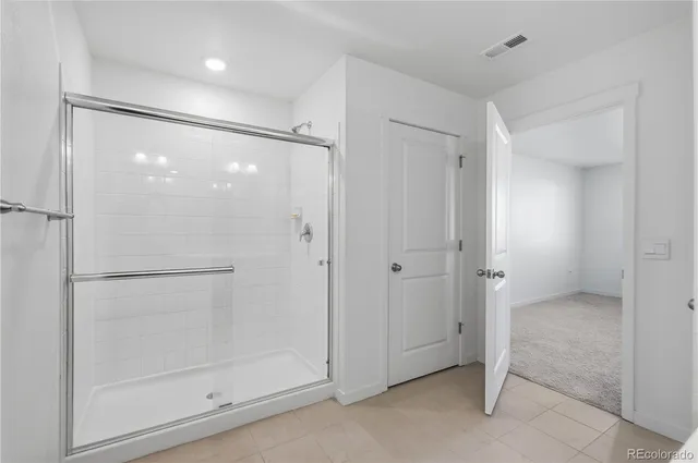 a bathroom with a glass shower door