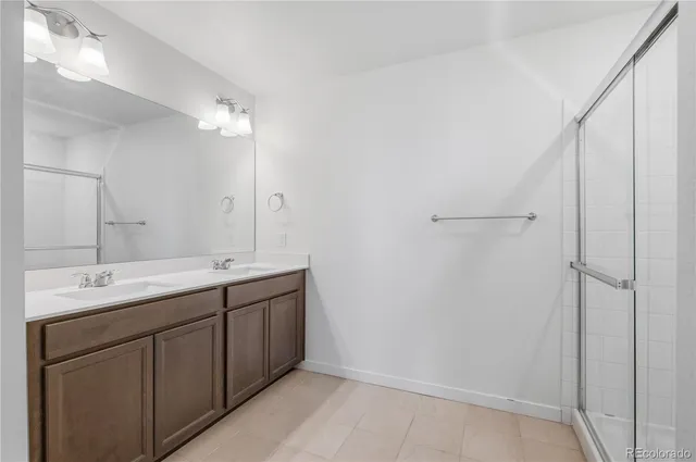 a bathroom with 2 sink and a mirror