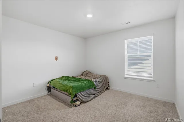 a room with a bed and a window