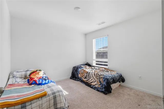 a bedroom with bed and a window