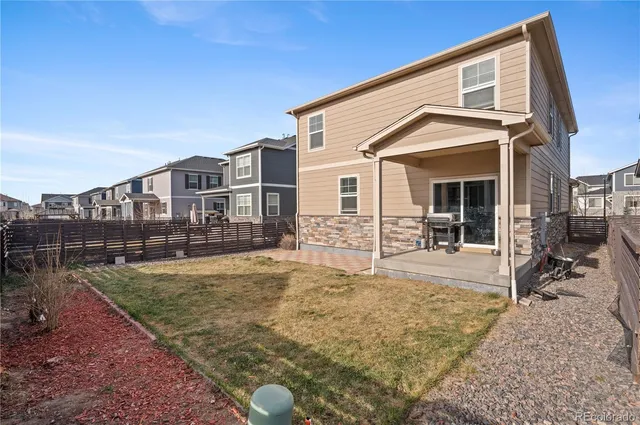 a view of a house with backyard porch and sitting area