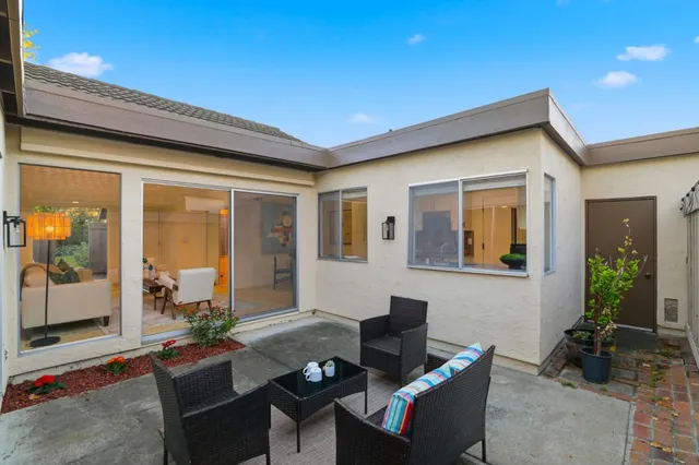 a view of a house with a big yard and large trees