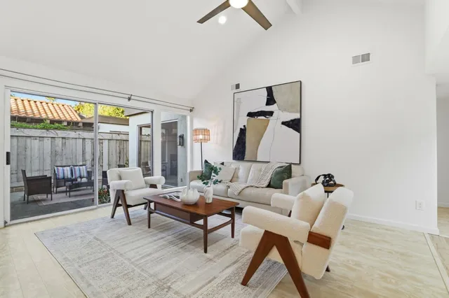 a kitchen with granite countertop a stove sink and refrigerator
