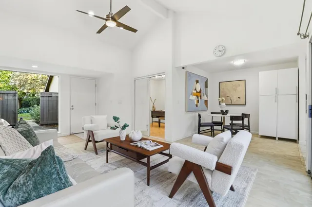 a kitchen with refrigerator a sink and white cabinets