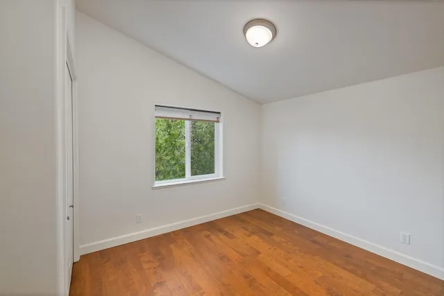 a view of balcony with wooden floor and dining space