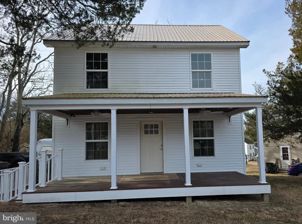 a front view of a house with stairs